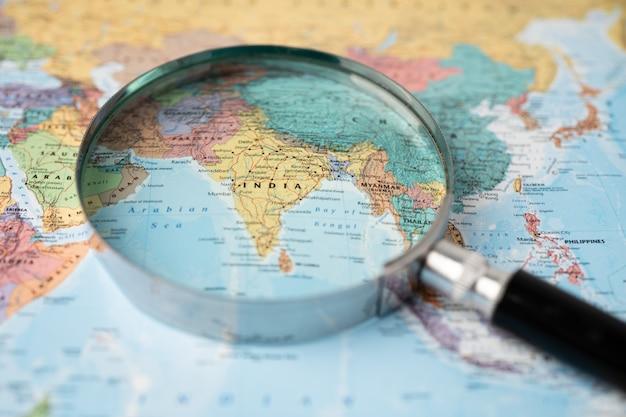 Premium Photo | India, magnifying glass close up with colorful world map.