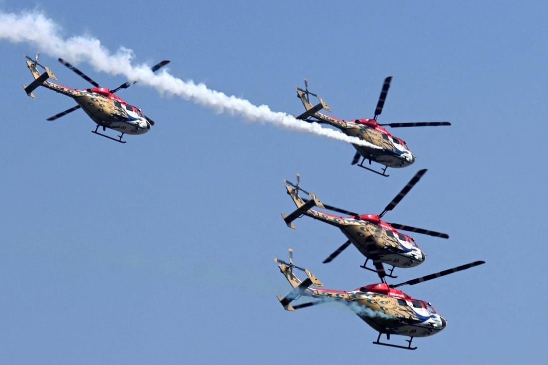 Advanced light helicopters of the Indian Air Force’s “Sarang” display team perform last month in New Delhi. Photo: AFP